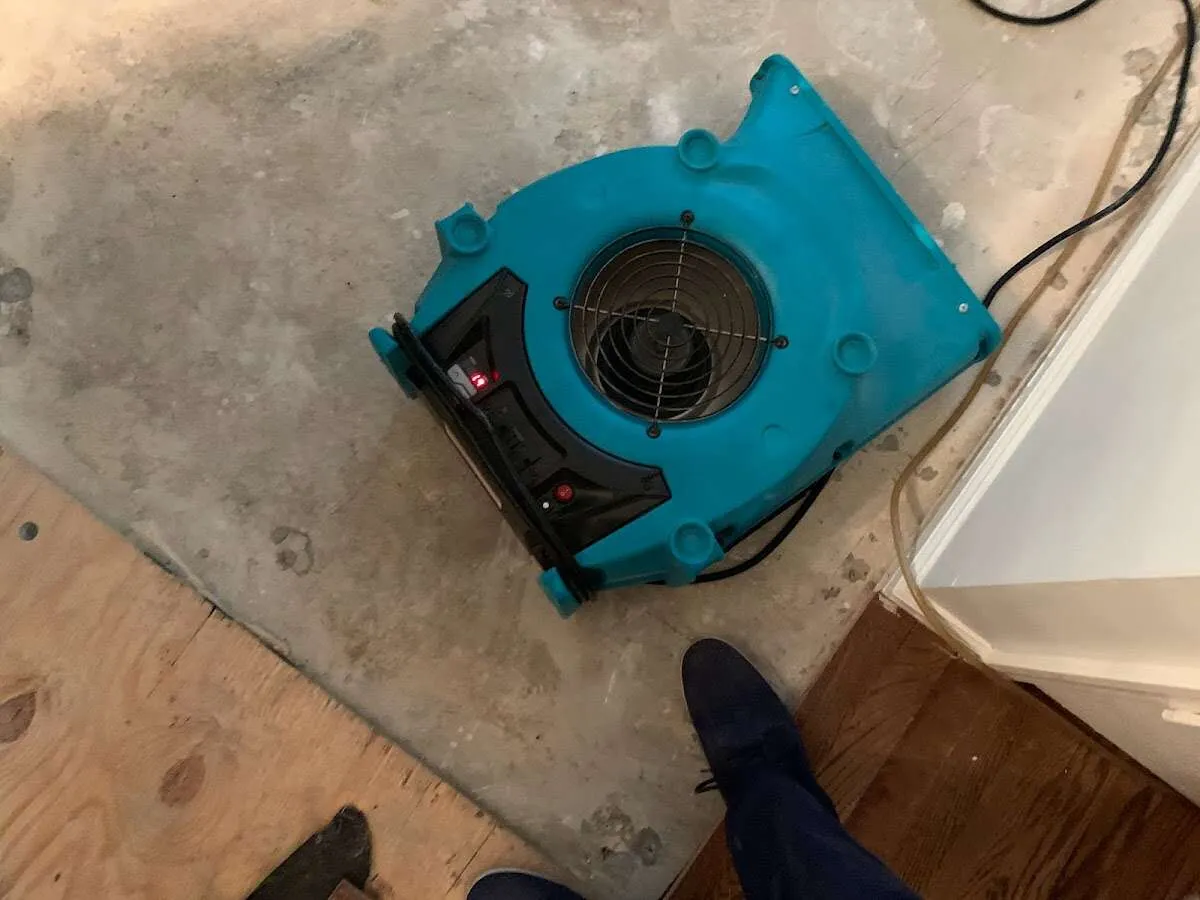 Air mover drying subfloor during Leak Detection & Repair in Deerfield